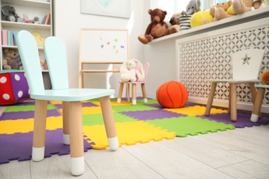 Photo of Stylish child room interior with different toys and furniture