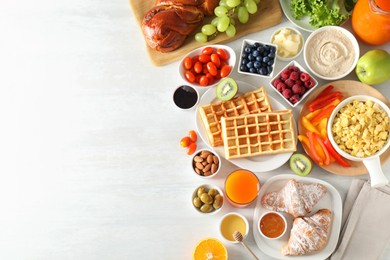 Photo of Tasty breakfast. Flat lay composition with many different food and juice on light wooden table. Space for text