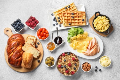 Photo of Tasty breakfast. Flat lay composition with many different food on grey textured table