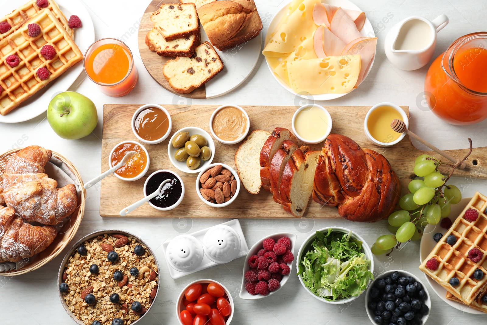 Photo of Different meals served for breakfast on white table, flat lay