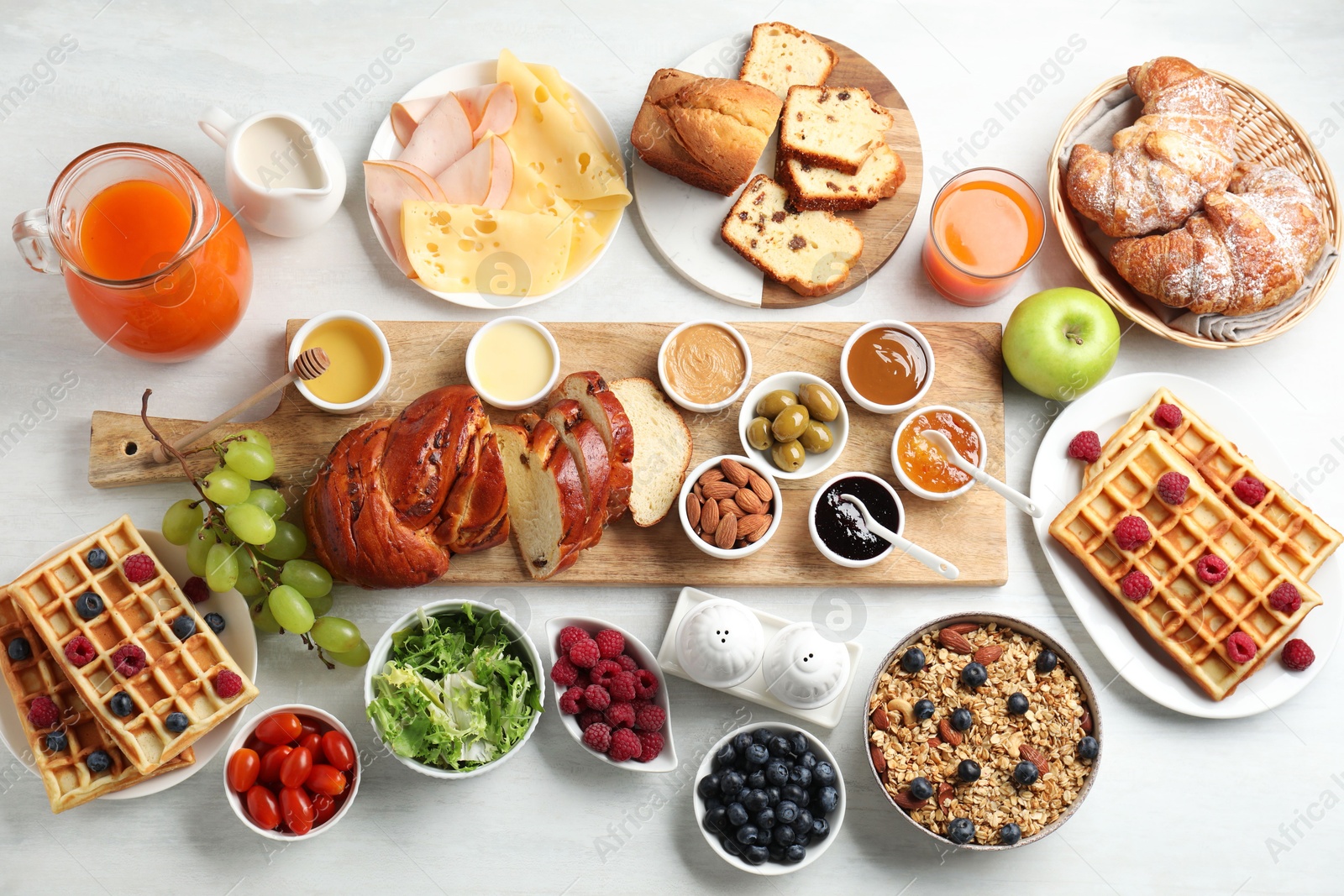 Photo of Different meals served for breakfast on white table, flat lay