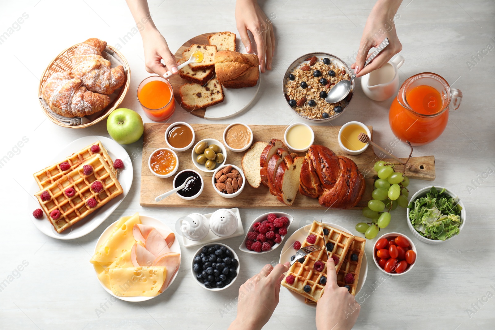 Photo of People having breakfast at white table, top view