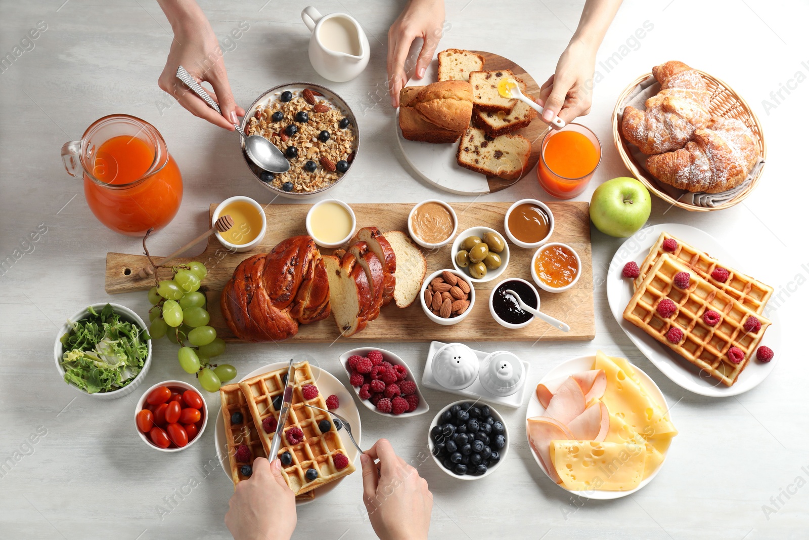 Photo of People having breakfast at white table, top view