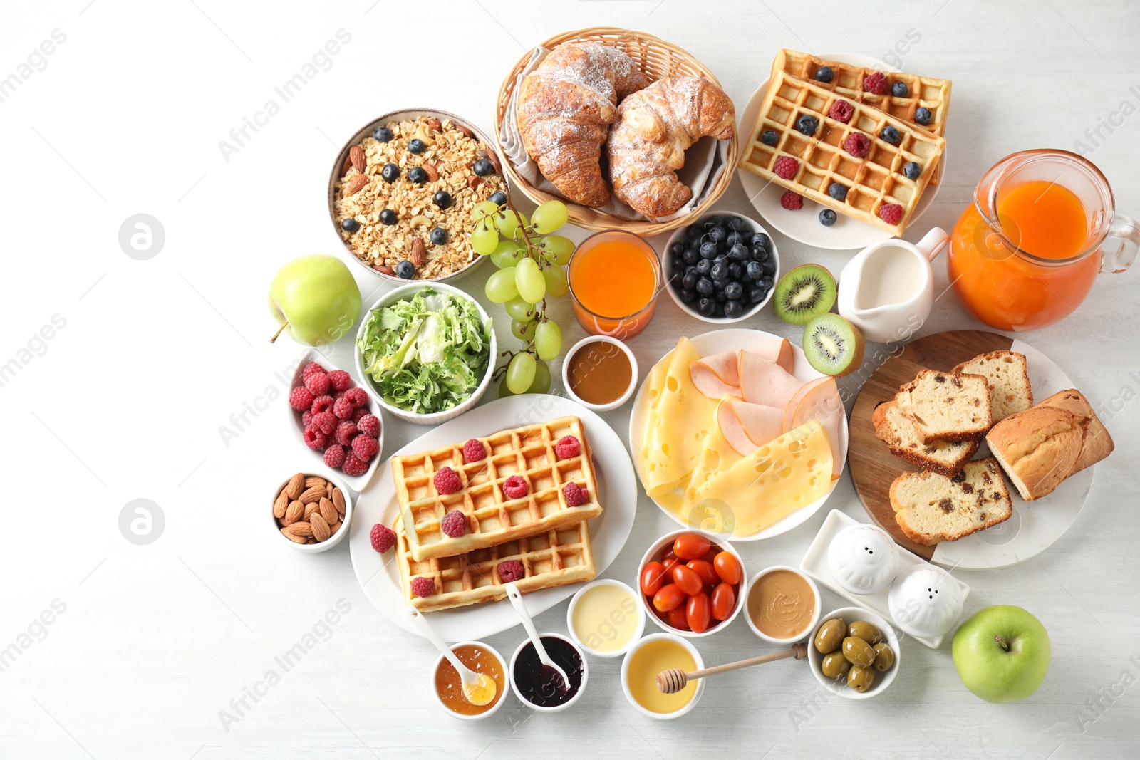 Photo of Different meals served for breakfast on white table, flat lay