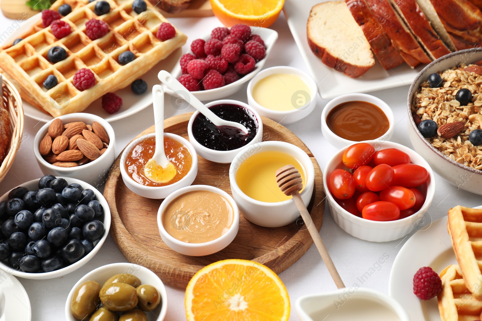 Photo of Different meals served for breakfast on white table