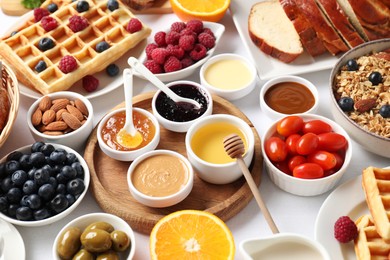 Photo of Different meals served for breakfast on white table