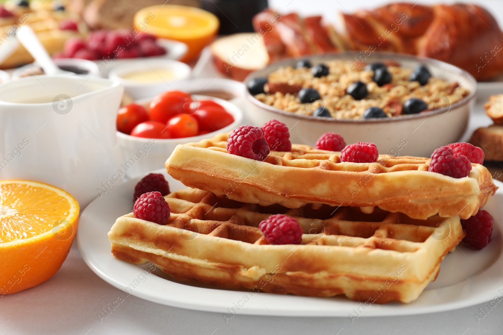 Photo of Different meals served for breakfast on white table, closeup. Buffet menu