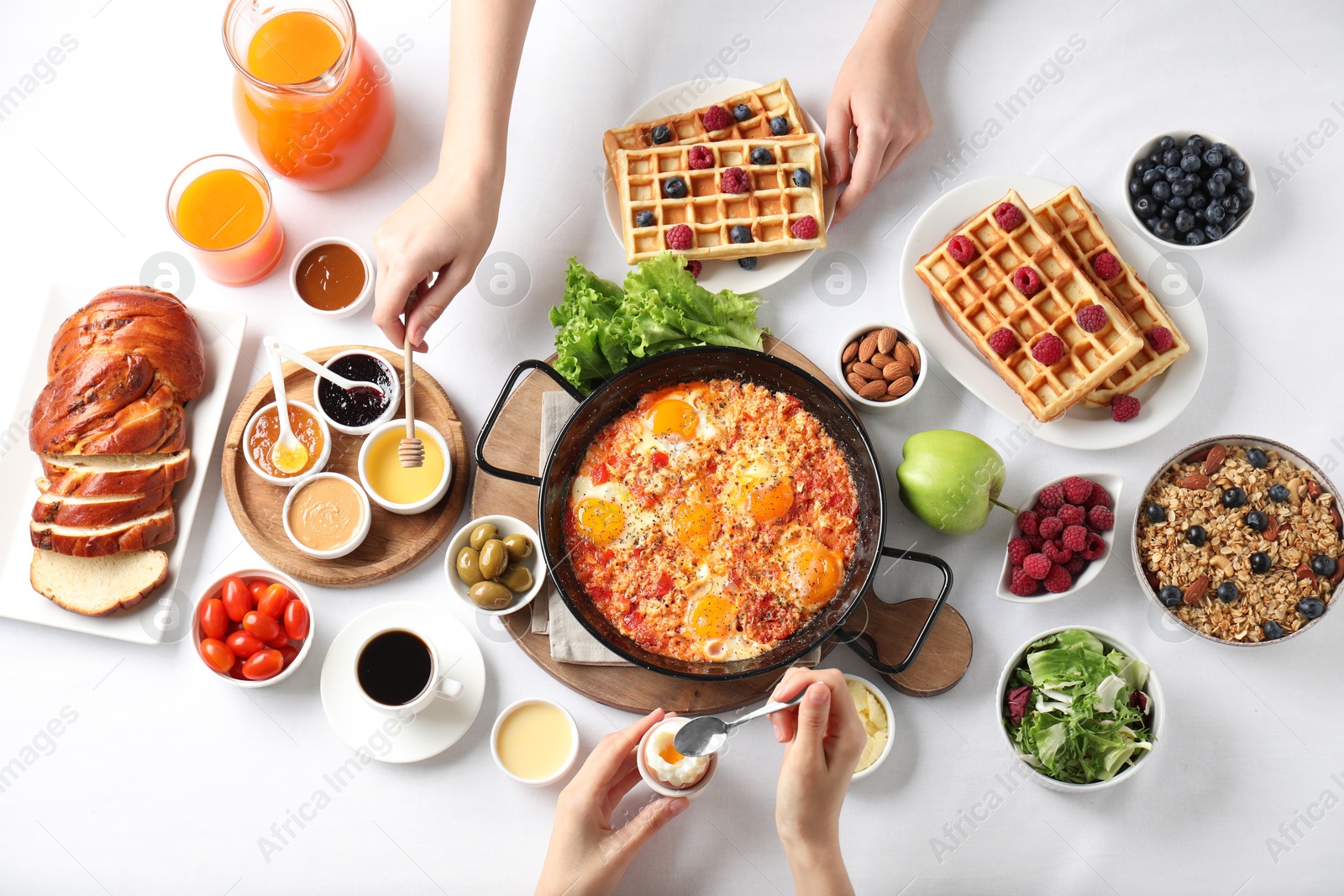 Photo of People having breakfast at white table, top view