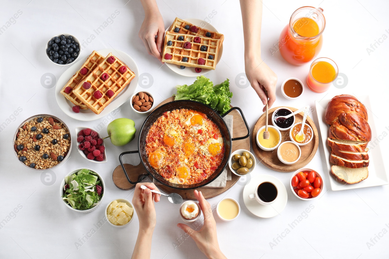 Photo of People having breakfast at white table, top view