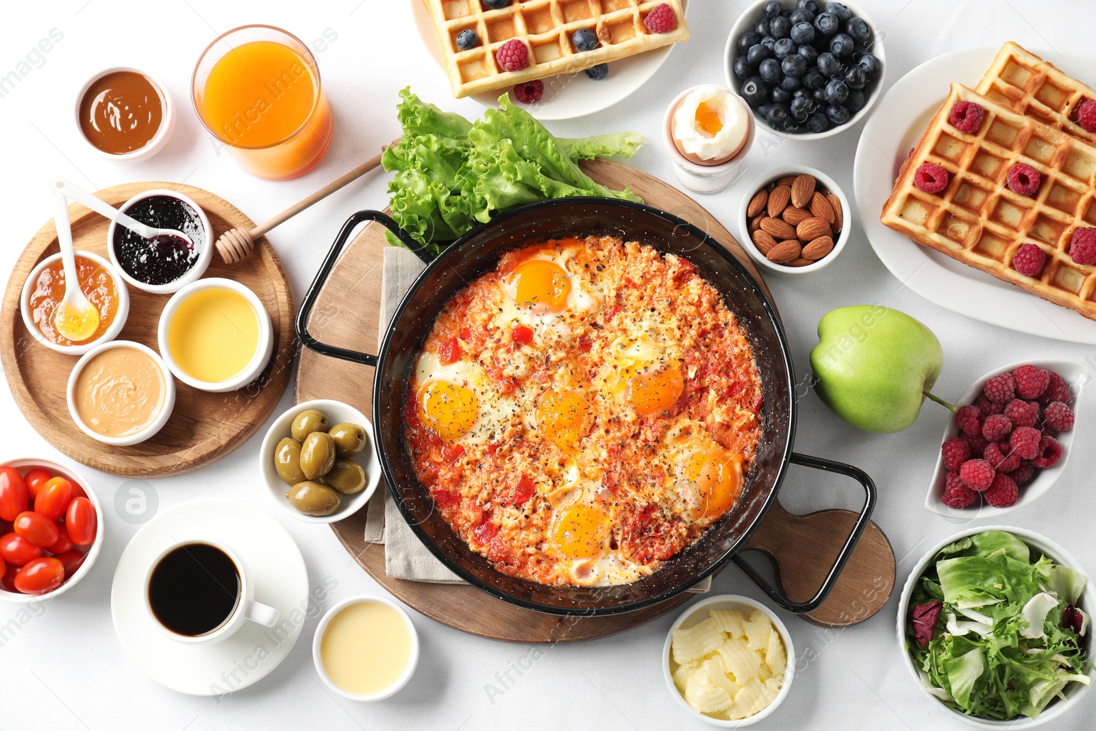 Photo of Different meals served for breakfast on white table, flat lay