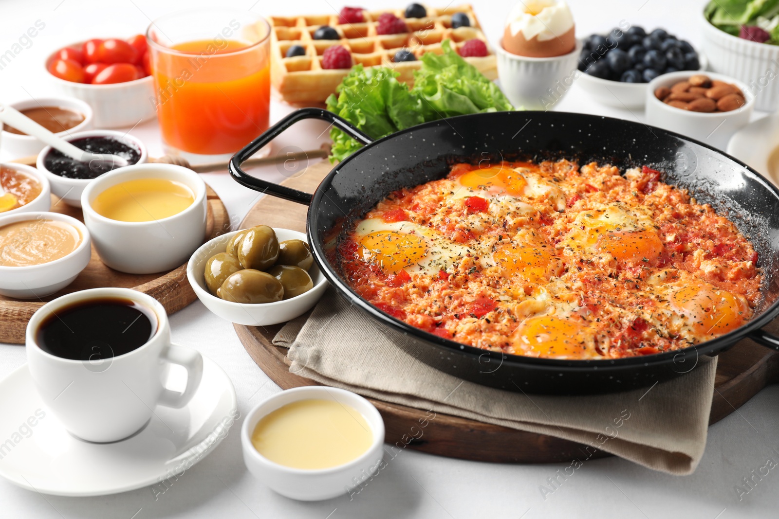 Photo of Cup of coffee and different meals served for breakfast on white table