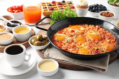 Photo of Cup of coffee and different meals served for breakfast on white table