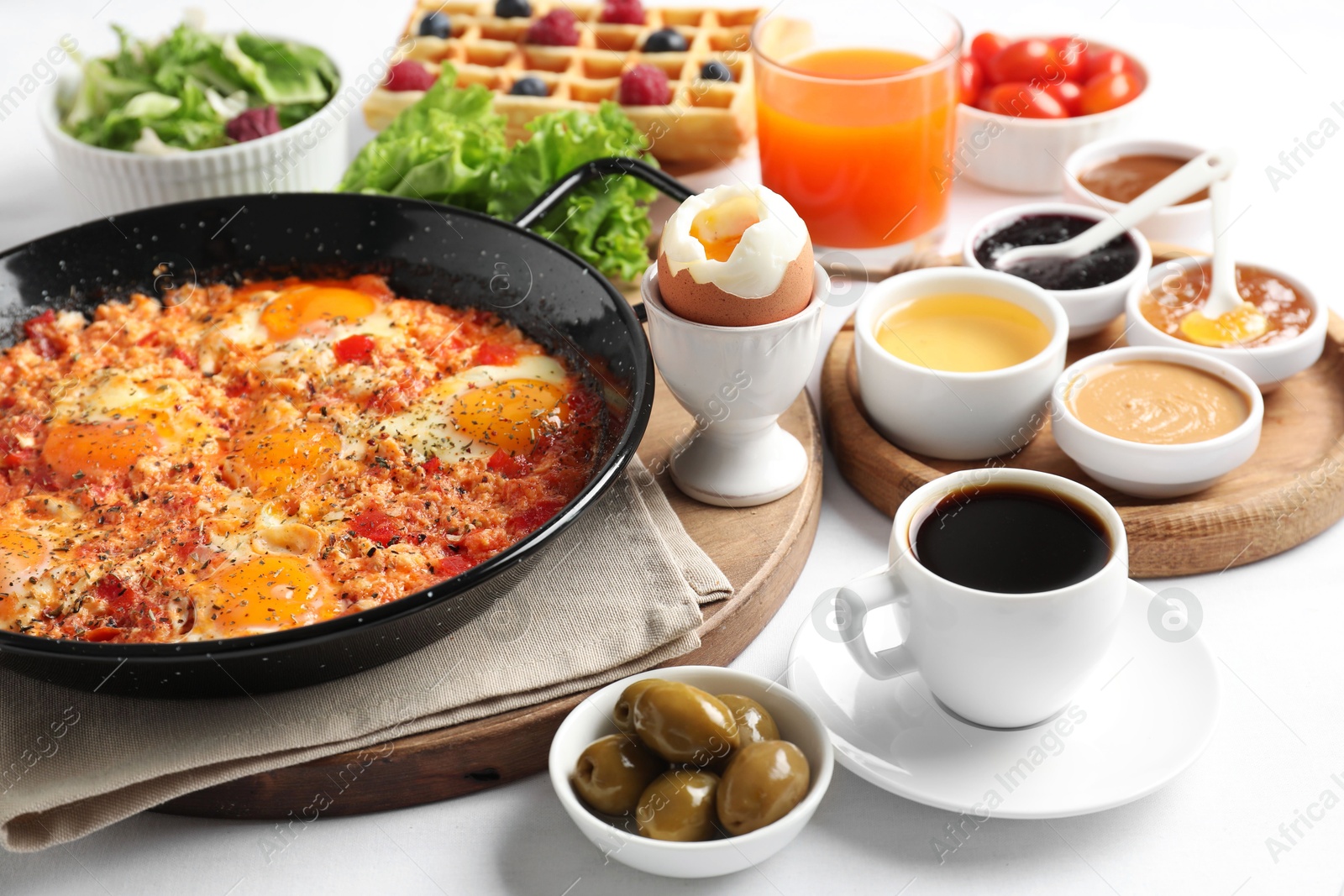 Photo of Cup of coffee and different meals served for breakfast on white table