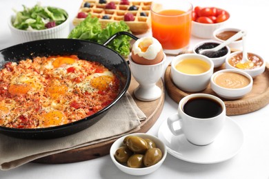 Photo of Cup of coffee and different meals served for breakfast on white table