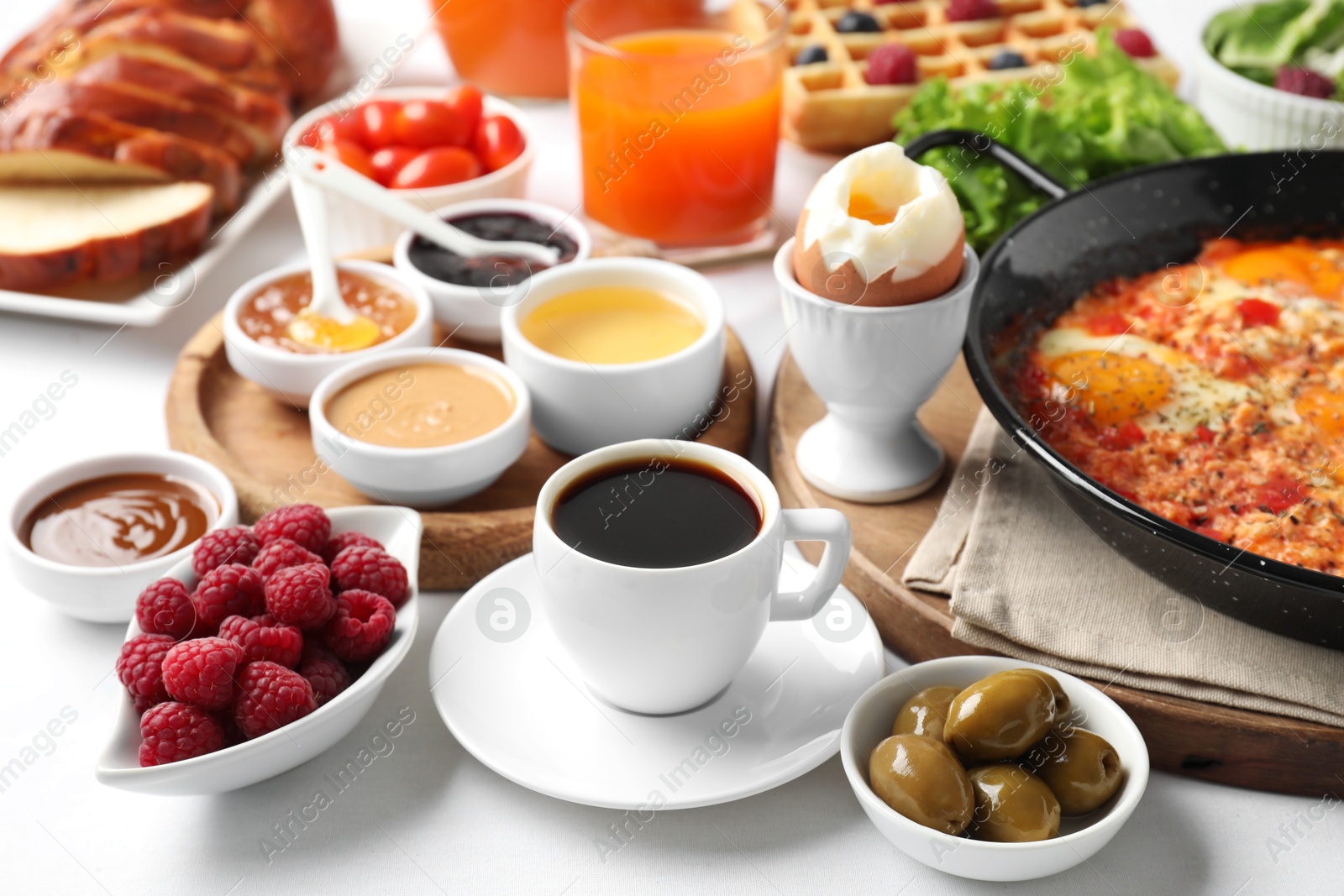 Photo of Cup of coffee and different meals served for breakfast on white table