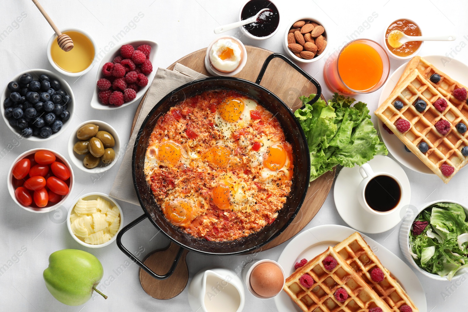 Photo of Different meals served for breakfast on white table, flat lay