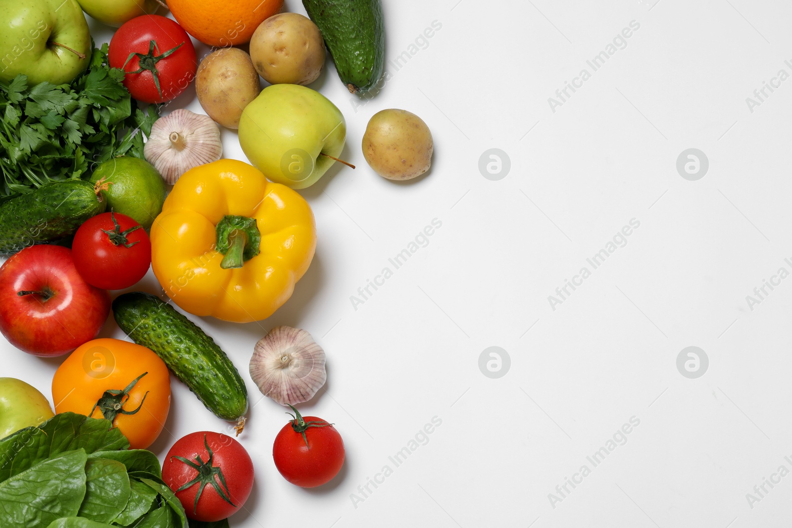 Photo of Healthy vegetarian food. Different vegetables and fruits on white background, flat lay. Space for text