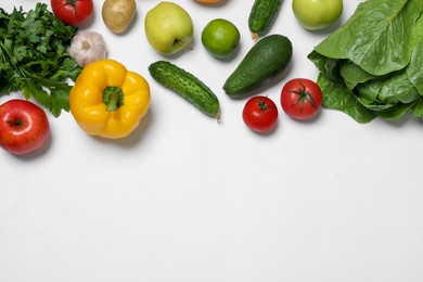 Healthy vegetarian food. Different vegetables and fruits on white background, flat lay. Space for text