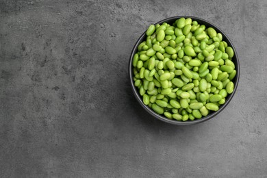 Photo of Raw green edamame soybeans on grey table, top view. Space for text