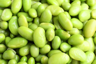 Raw green edamame soybeans as background, closeup