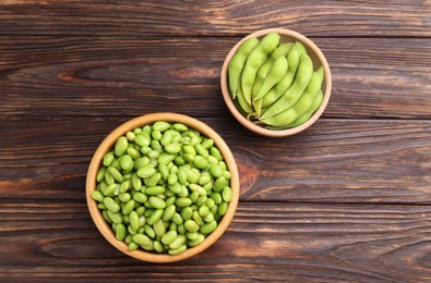 Photo of Raw green edamame soybeans and pods on wooden table, top view