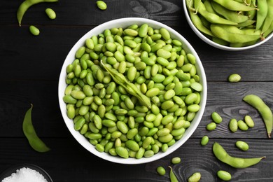 Photo of Raw green edamame soybeans and pods on wooden table, flat lay