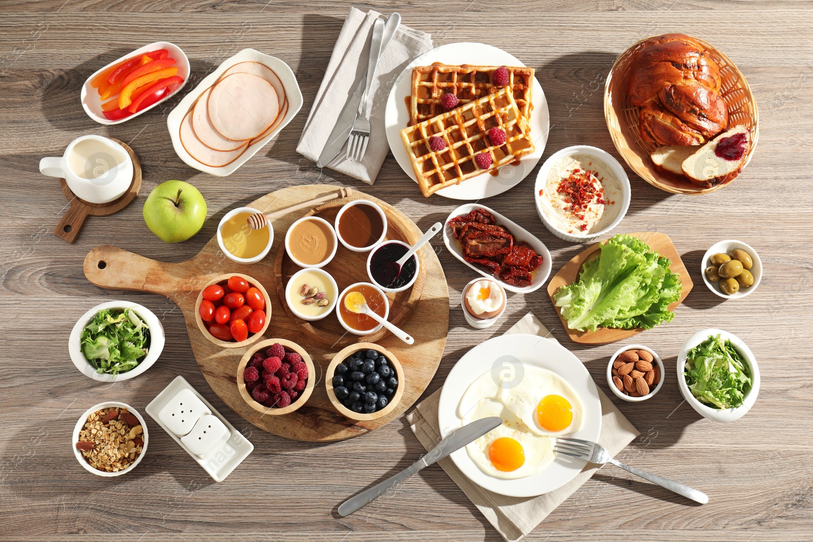 Photo of Different meals served for breakfast on wooden table, flat lay