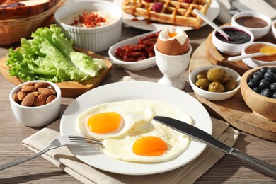 Photo of Different meals served for breakfast on wooden table