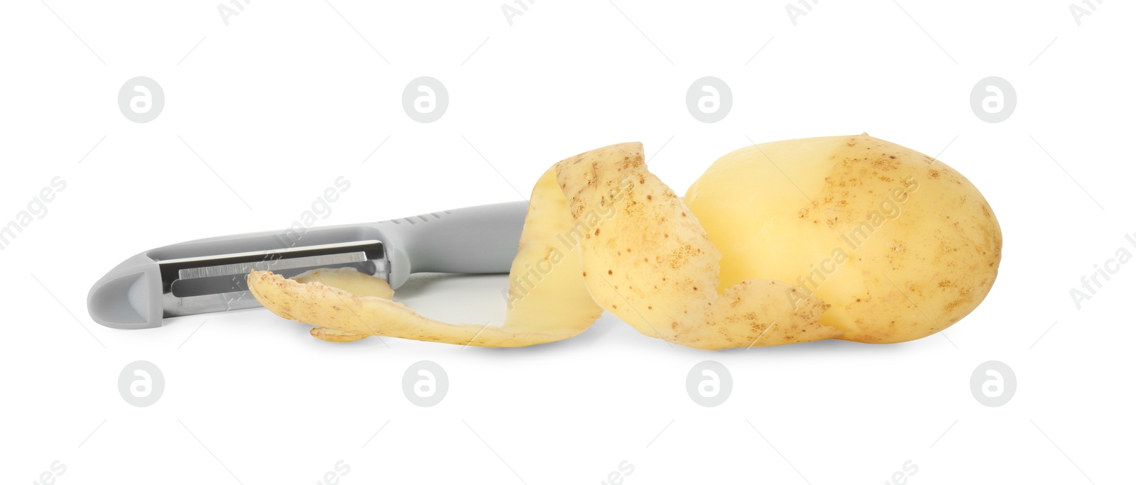 Photo of Young potato, peel and peeler isolated on white