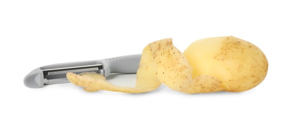 Photo of Young potato, peel and peeler isolated on white