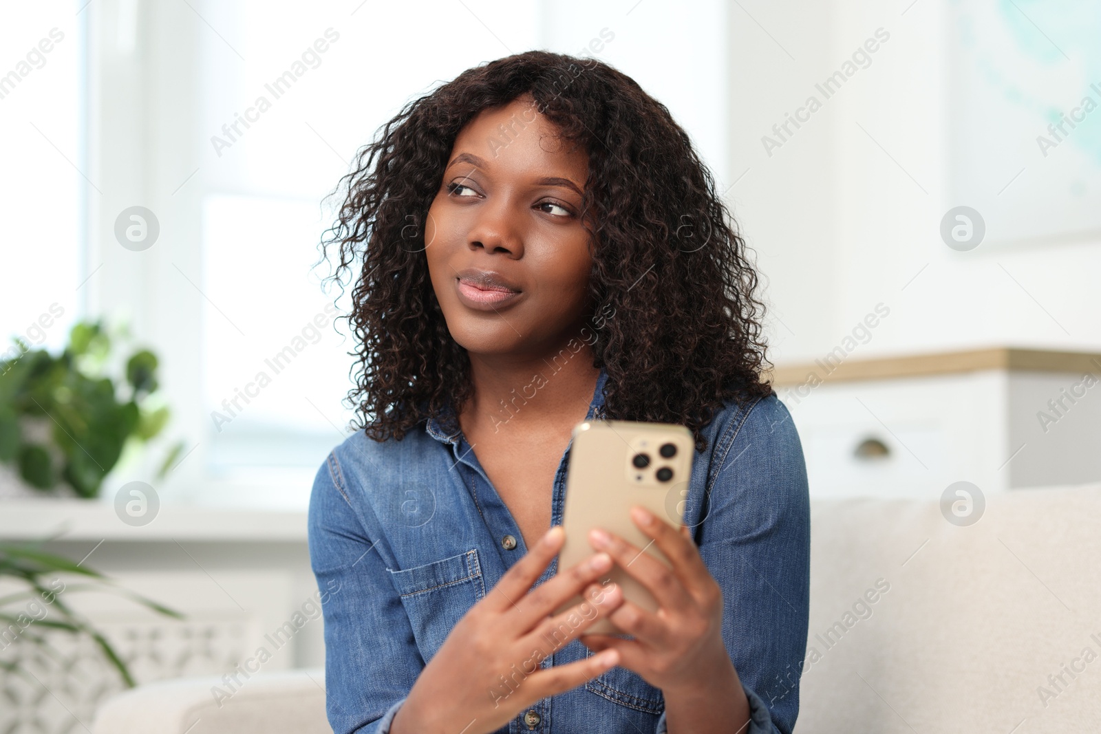 Photo of Beautiful woman with mobile phone at home