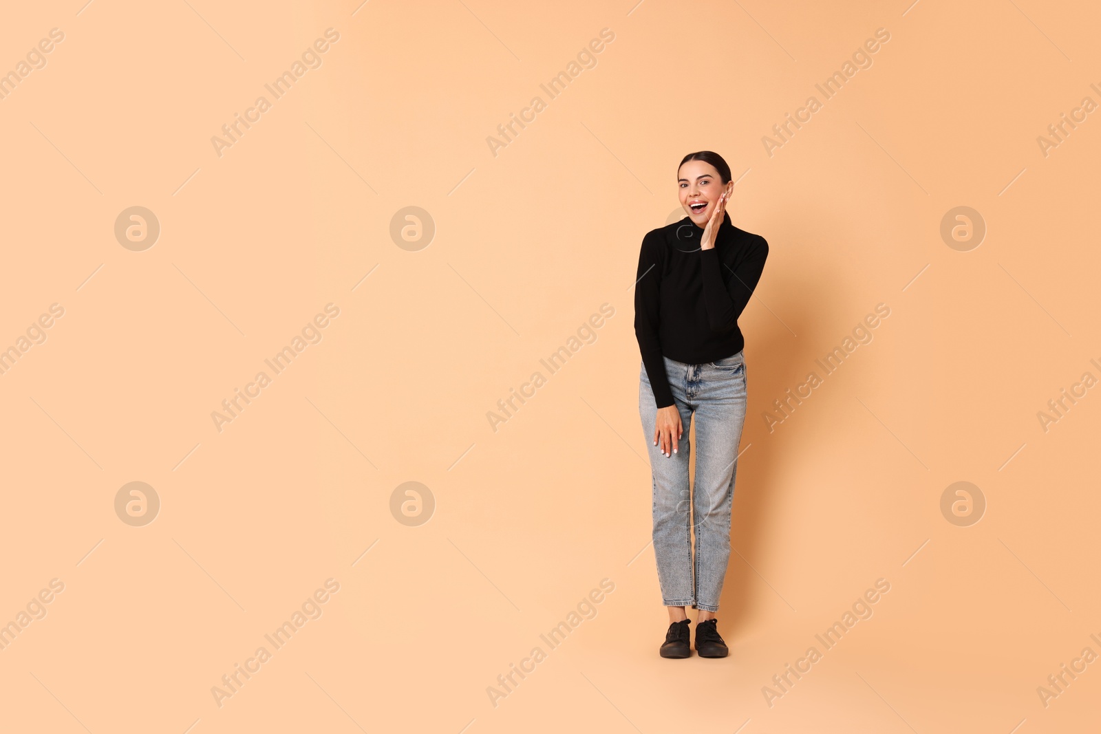 Photo of Happy woman on beige background. Space for text