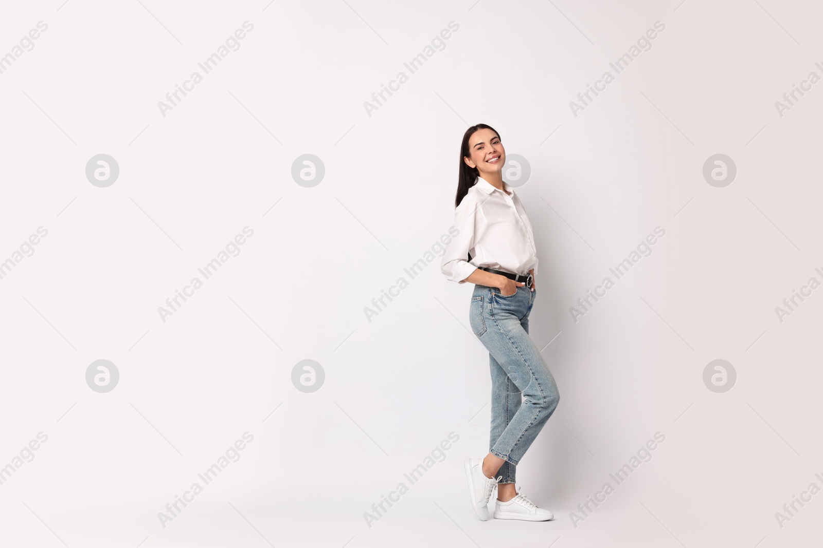 Photo of Smiling woman on white background. Space for text