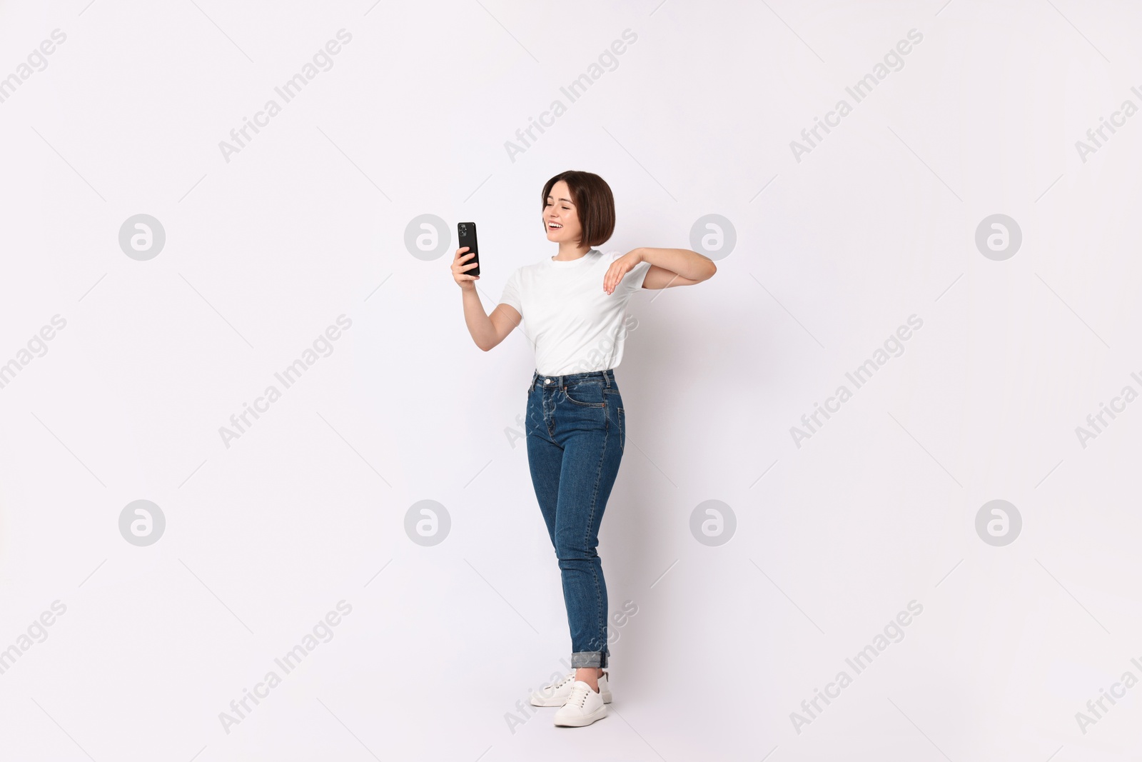 Photo of Happy woman with smartphone on white background