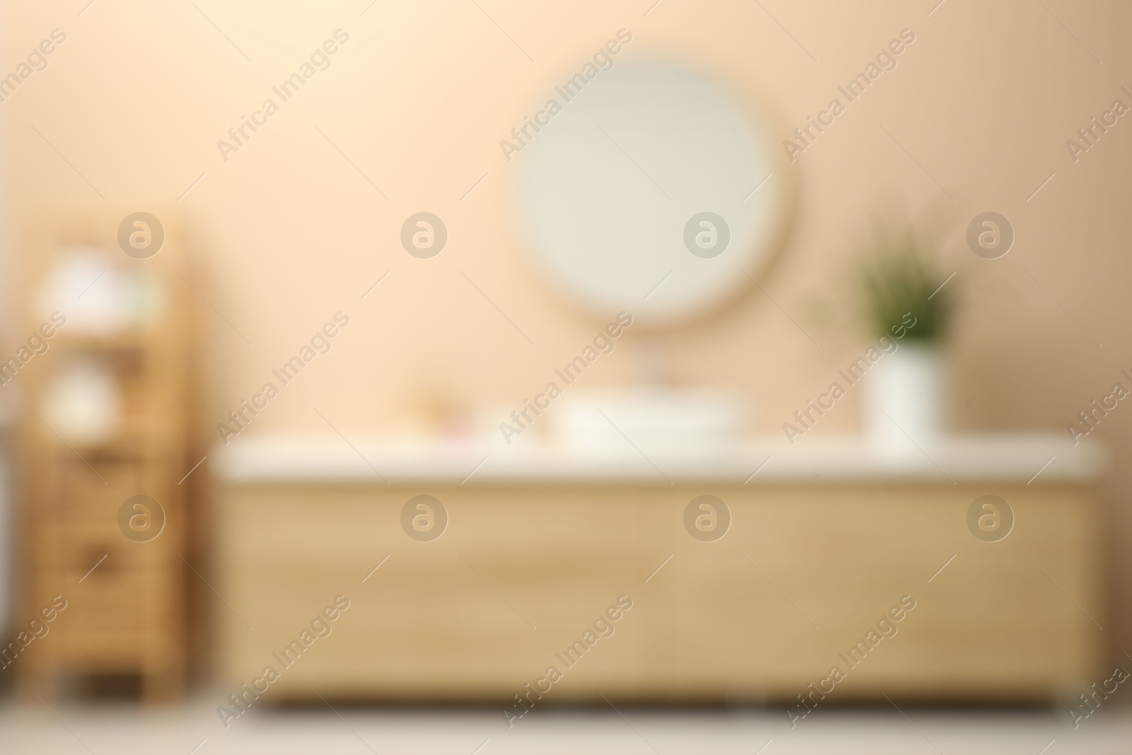 Photo of Blurred view of furniture and mirror in bathroom