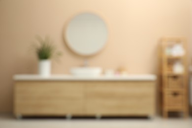 Photo of Blurred view of furniture and mirror in bathroom