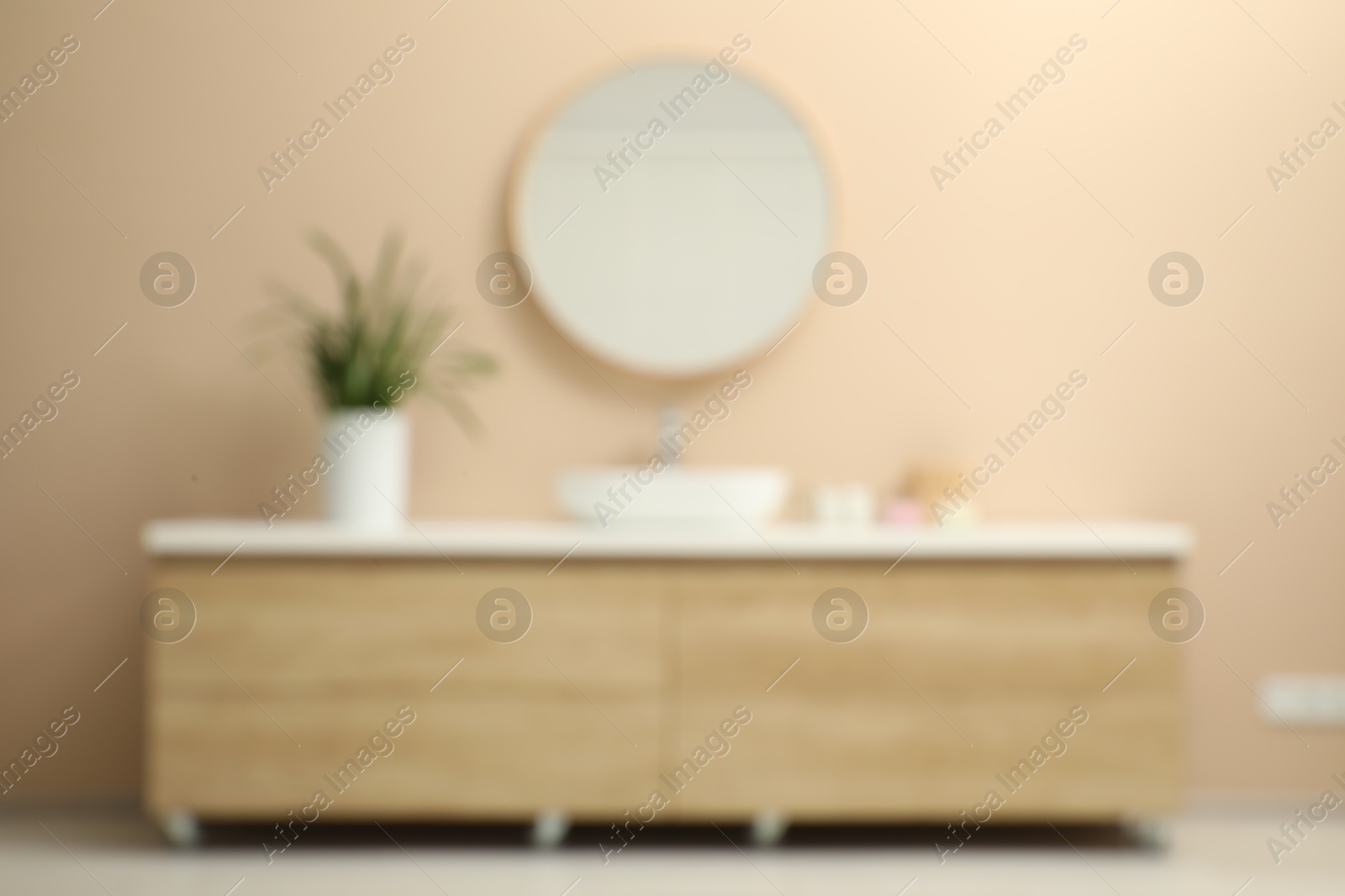 Photo of Blurred view of vanity and mirror in bathroom