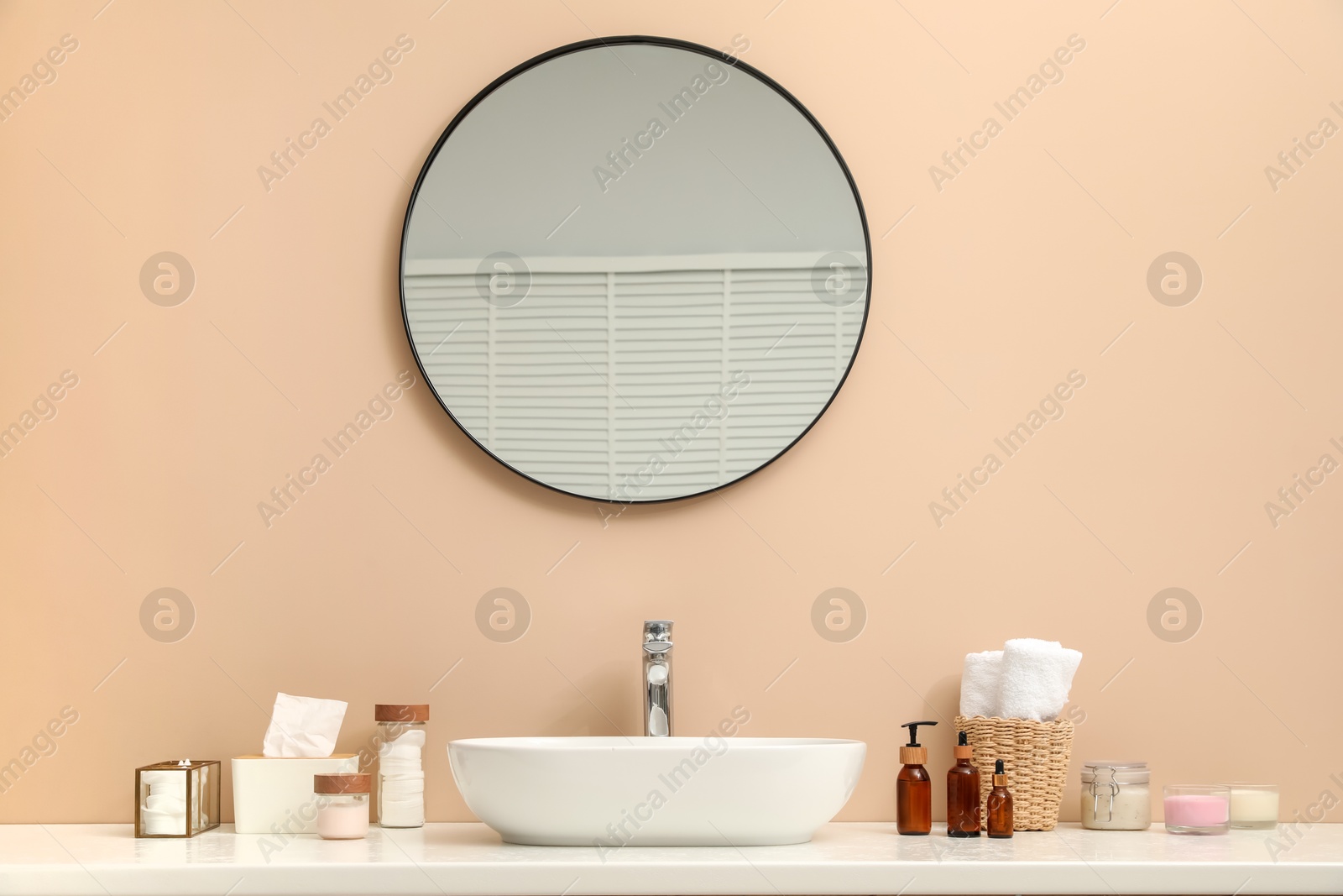 Photo of Countertop with sink, toiletries and mirror in bathroom