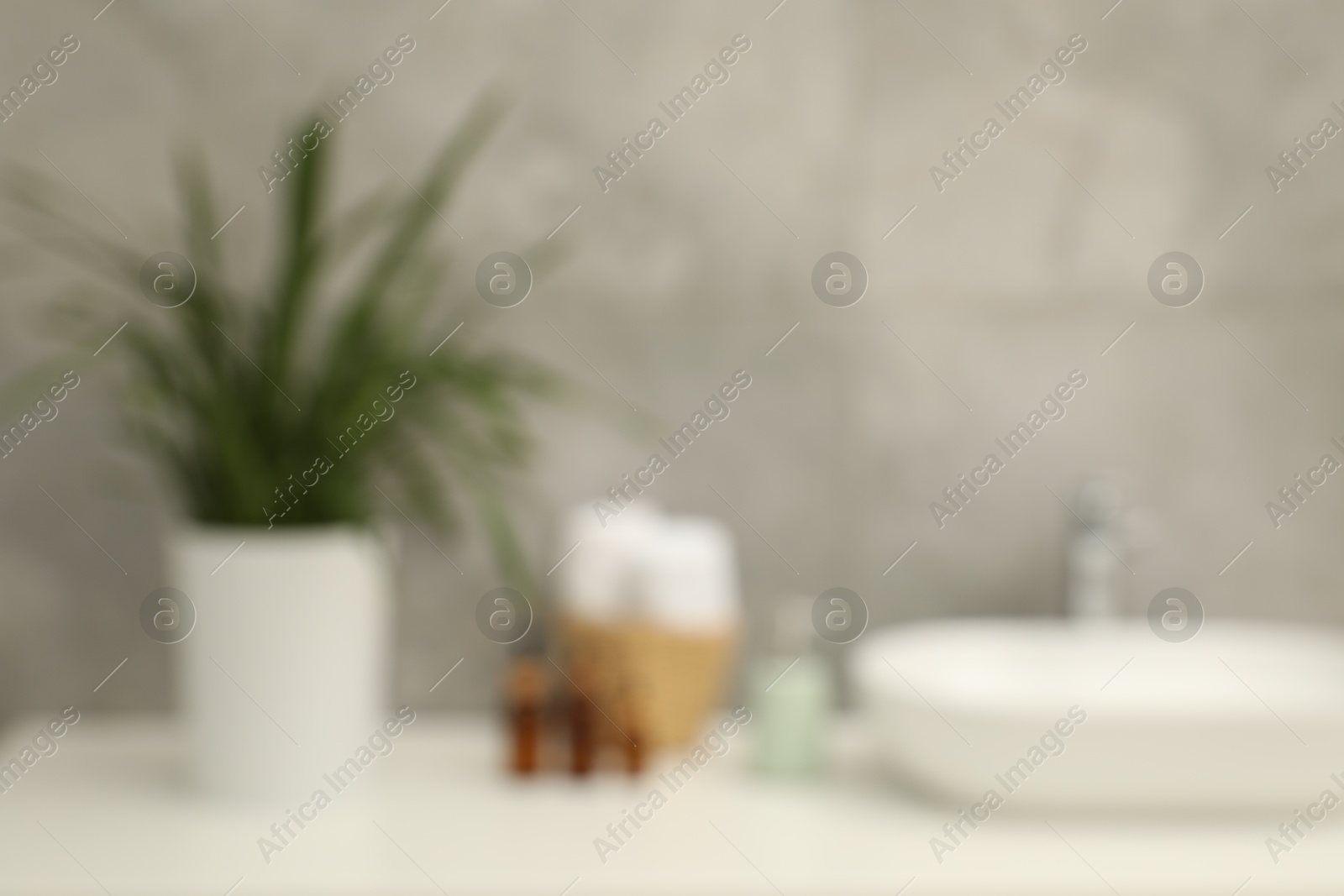 Photo of Blurred view of countertop with sink and toiletries in bathroom