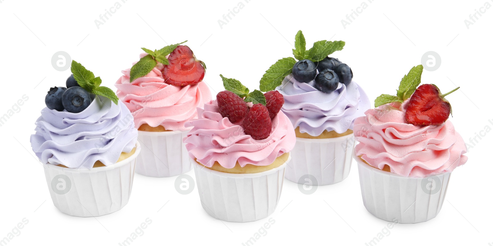 Photo of Tasty cupcakes with different berries isolated on white