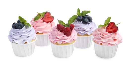 Photo of Tasty cupcakes with different berries isolated on white