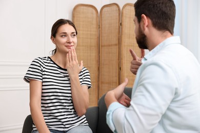 Man and woman using sign language for communication at home