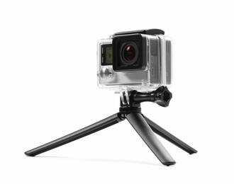 Photo of Modern action camera and tripod on white background