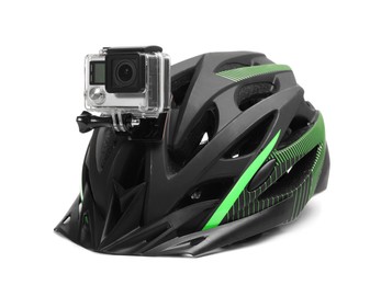 Modern action camera on helmet against white background