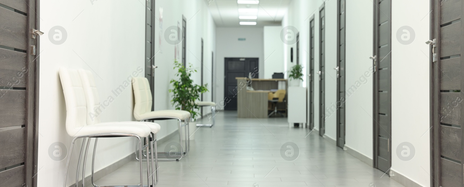 Photo of Empty hospital corridor with chairs and doors