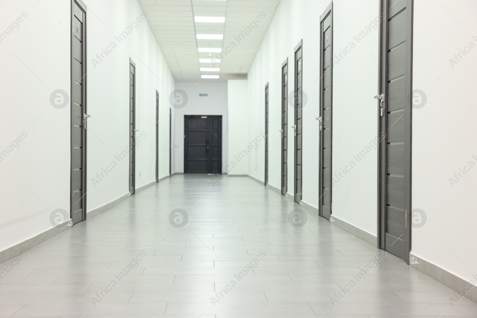 Photo of View of empty hospital corridor with wooden doors