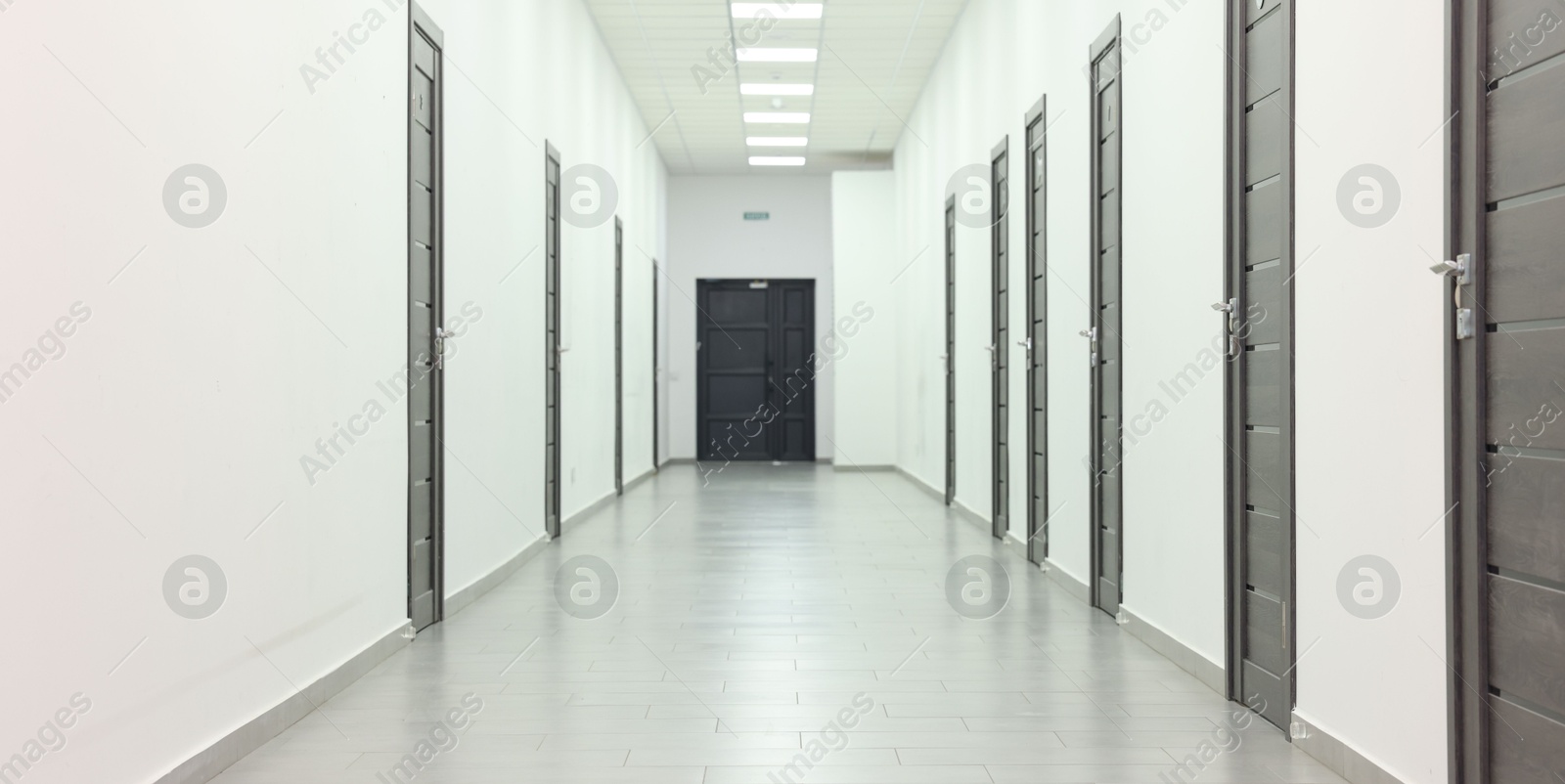 Photo of View of empty hospital corridor with wooden doors