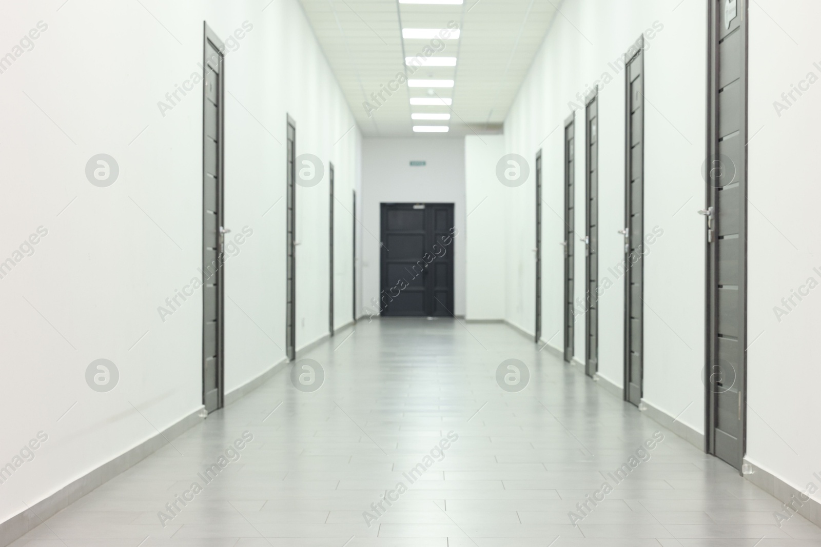 Photo of View of empty hospital corridor with wooden doors