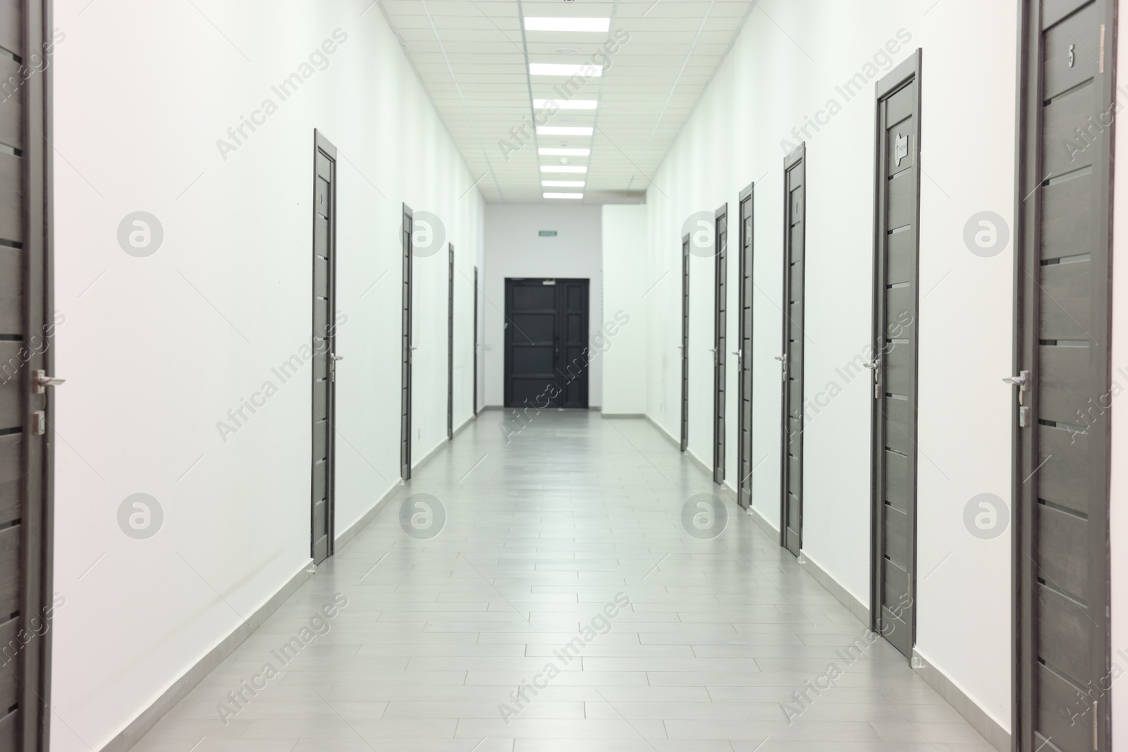 Photo of View of empty hospital corridor with wooden doors