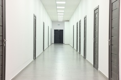 Photo of View of empty hospital corridor with wooden doors